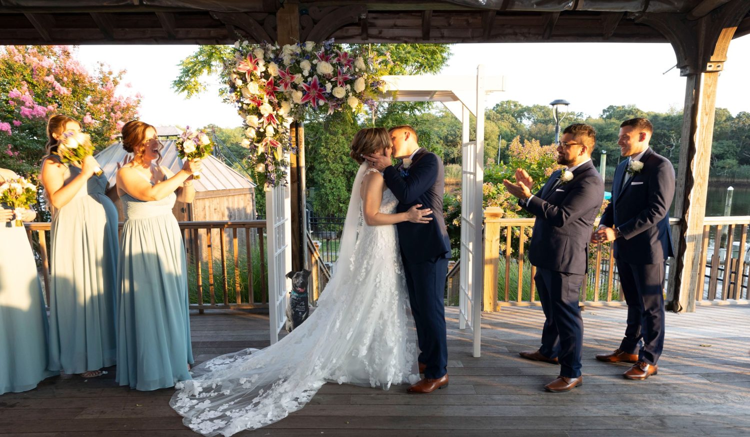 Bride and groom kiss after waterfront ceremony