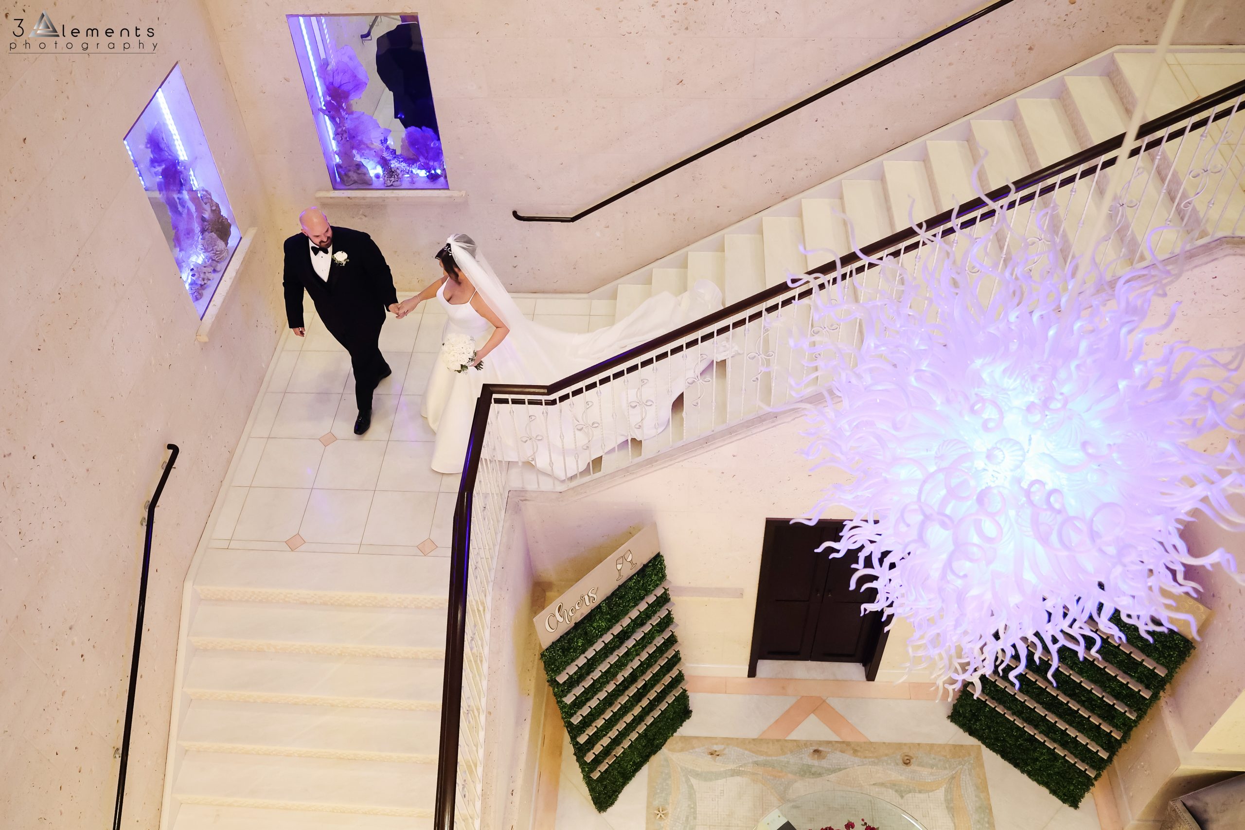 Overview of bride and groom walking down the stairs