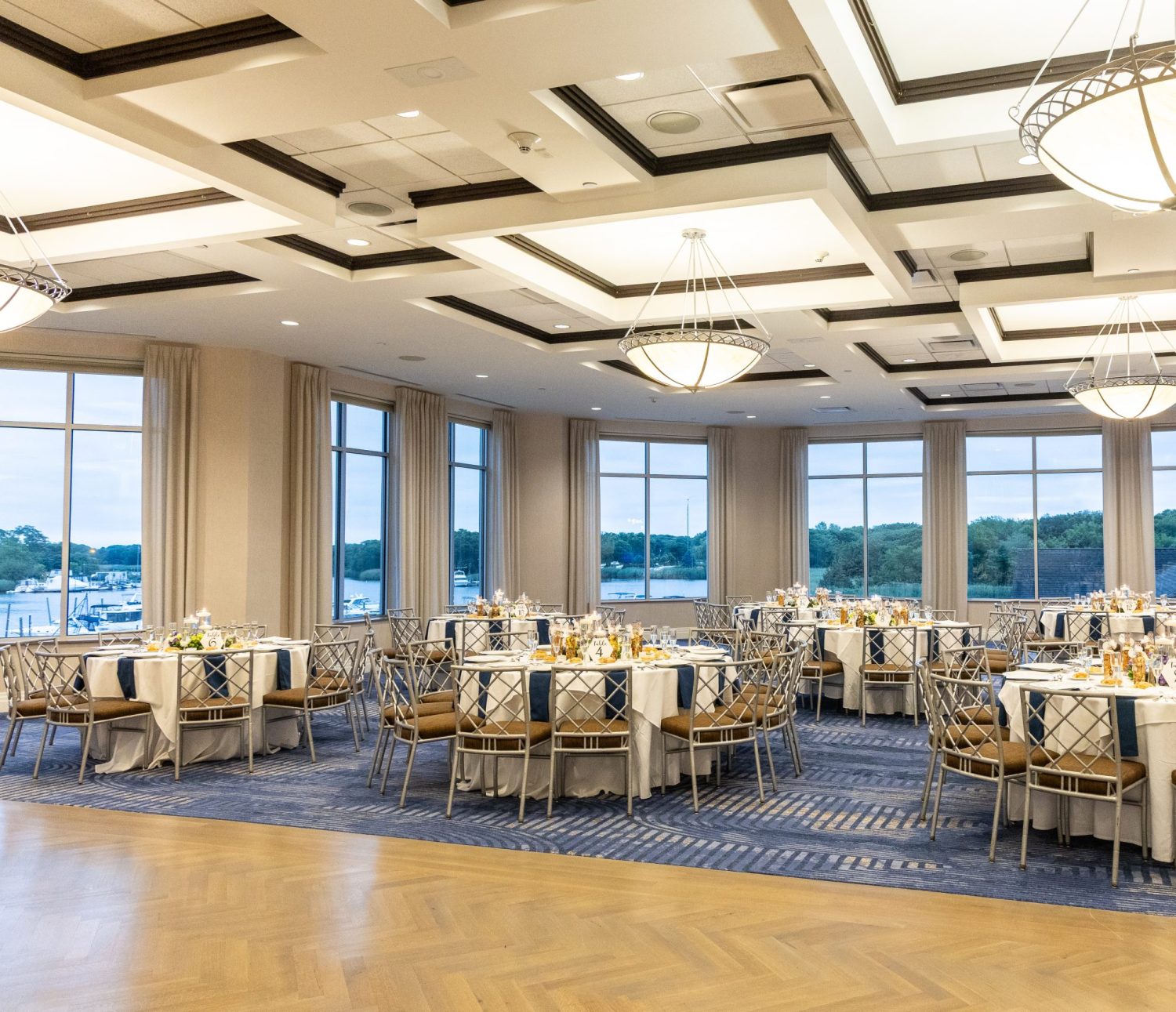 Ballroom with white table covers and blue napkins