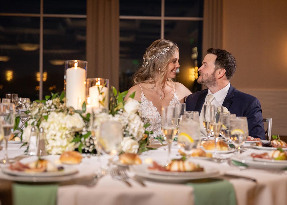 Bride and groom seated together at their wedding reception