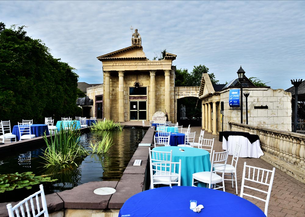 Outdoor reception tables beside the koi pond at Long Island Aquarium