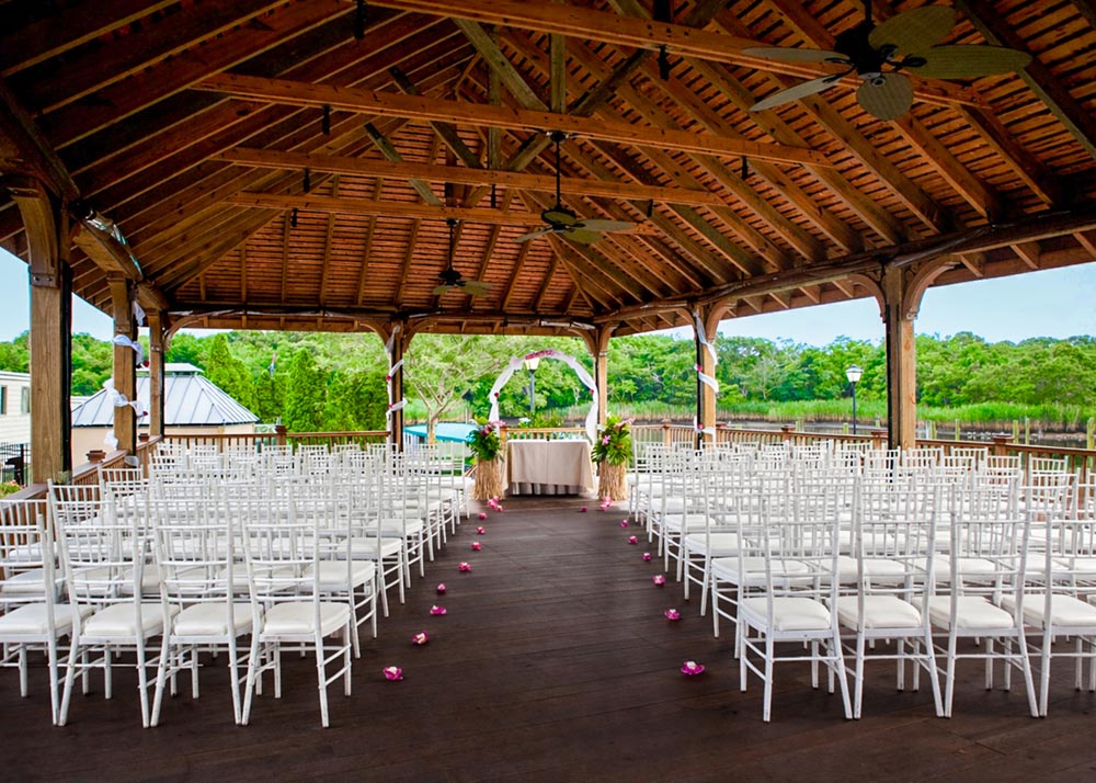 Waterfront wedding ceremony setup under the Riverside Pavilion